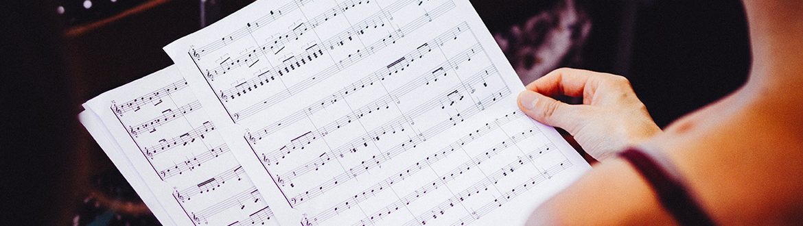 A female musician looking at sheet music